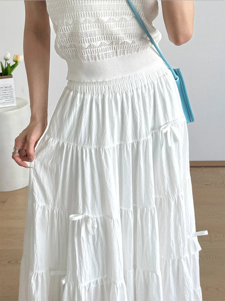 Tiered bow-accent maxi skirt with elastic smocked waist
