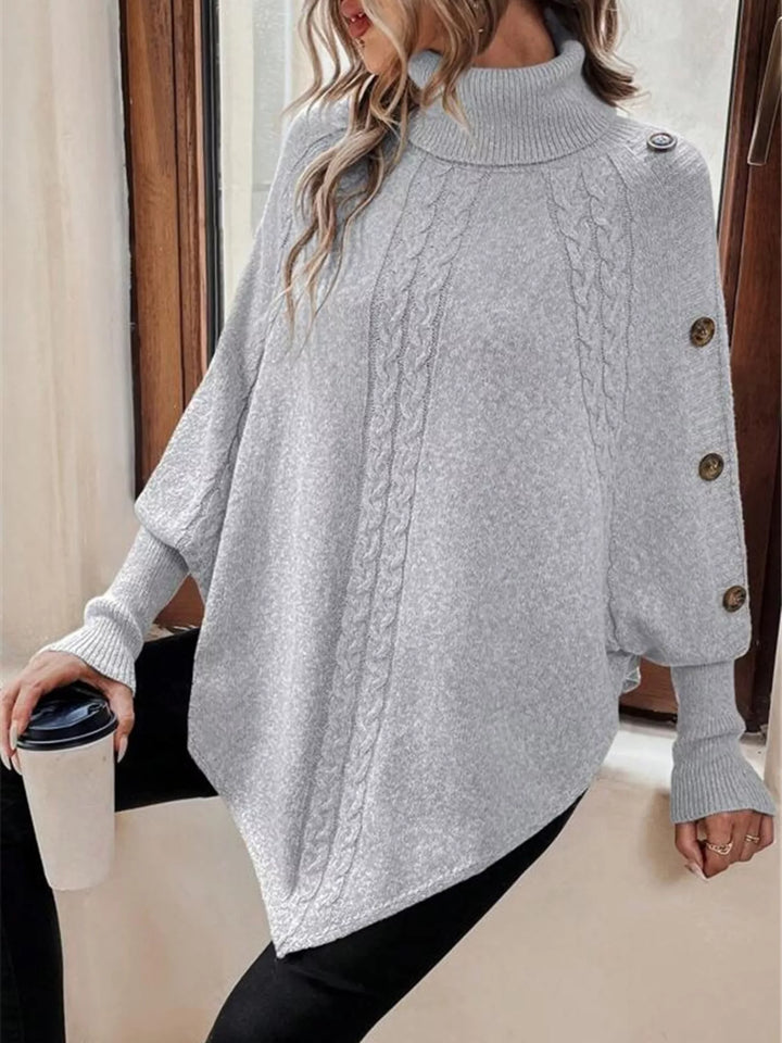 Cable knit turtleneck cape sweater with button shoulder