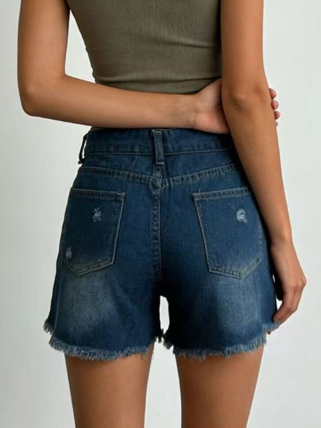 Distressed high-rise denim shorts with frayed raw hem
