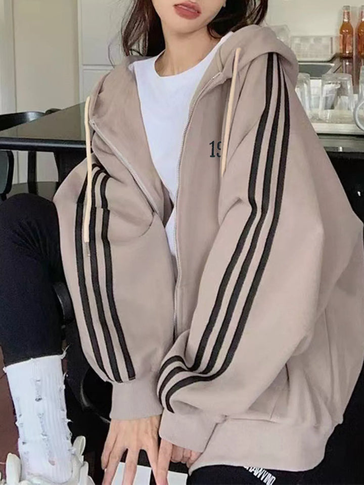 Oversized zip-up hoodie with striped sleeves and drawstring hood