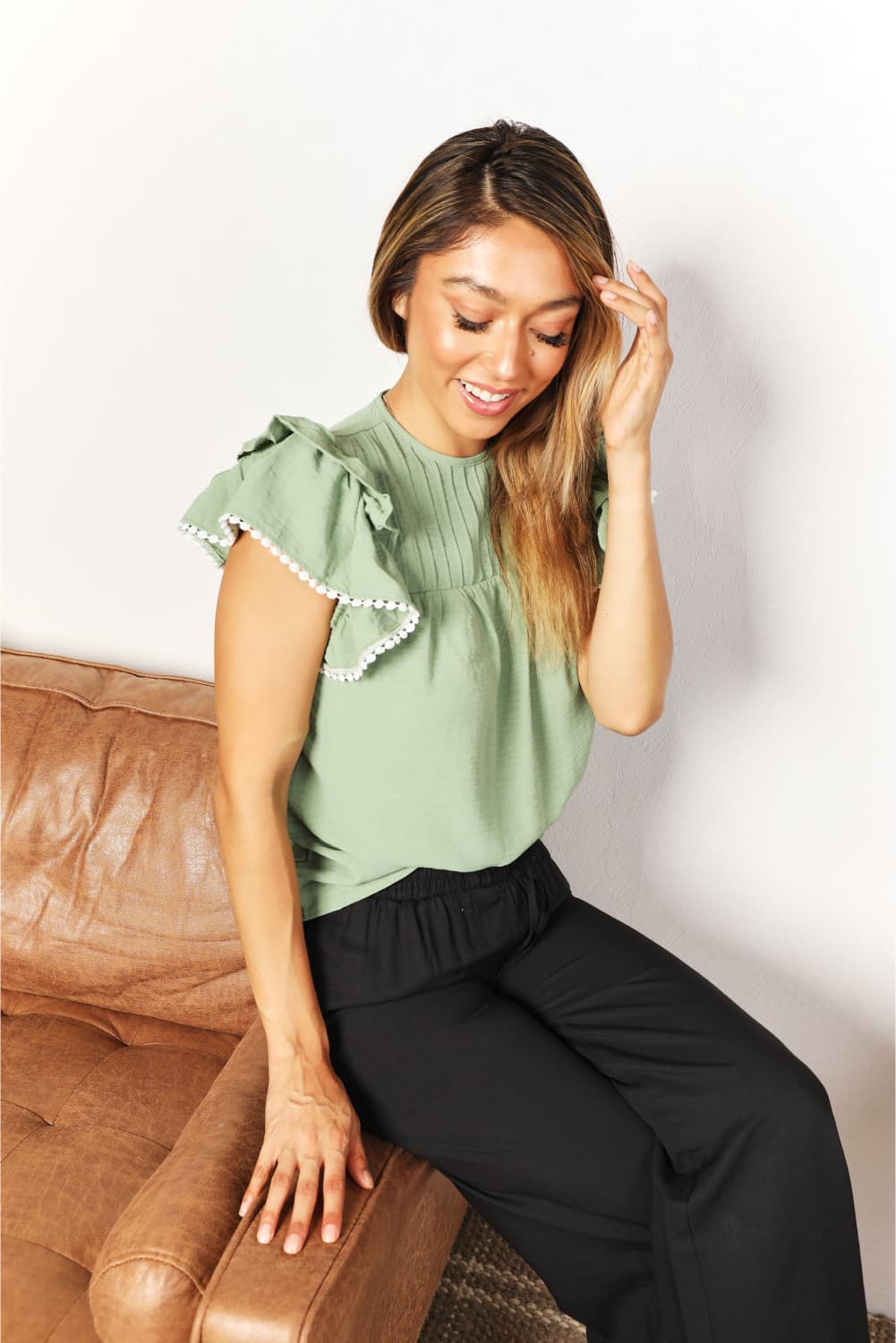Pintuck yoke flutter sleeve blouse with pom-pom trim
