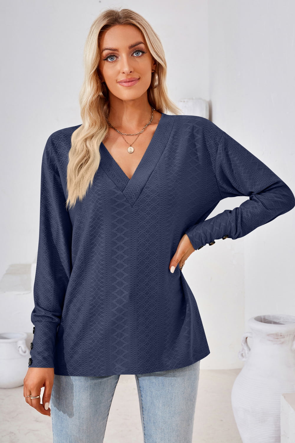 Textured knit V-neck long sleeve top with button cuffs