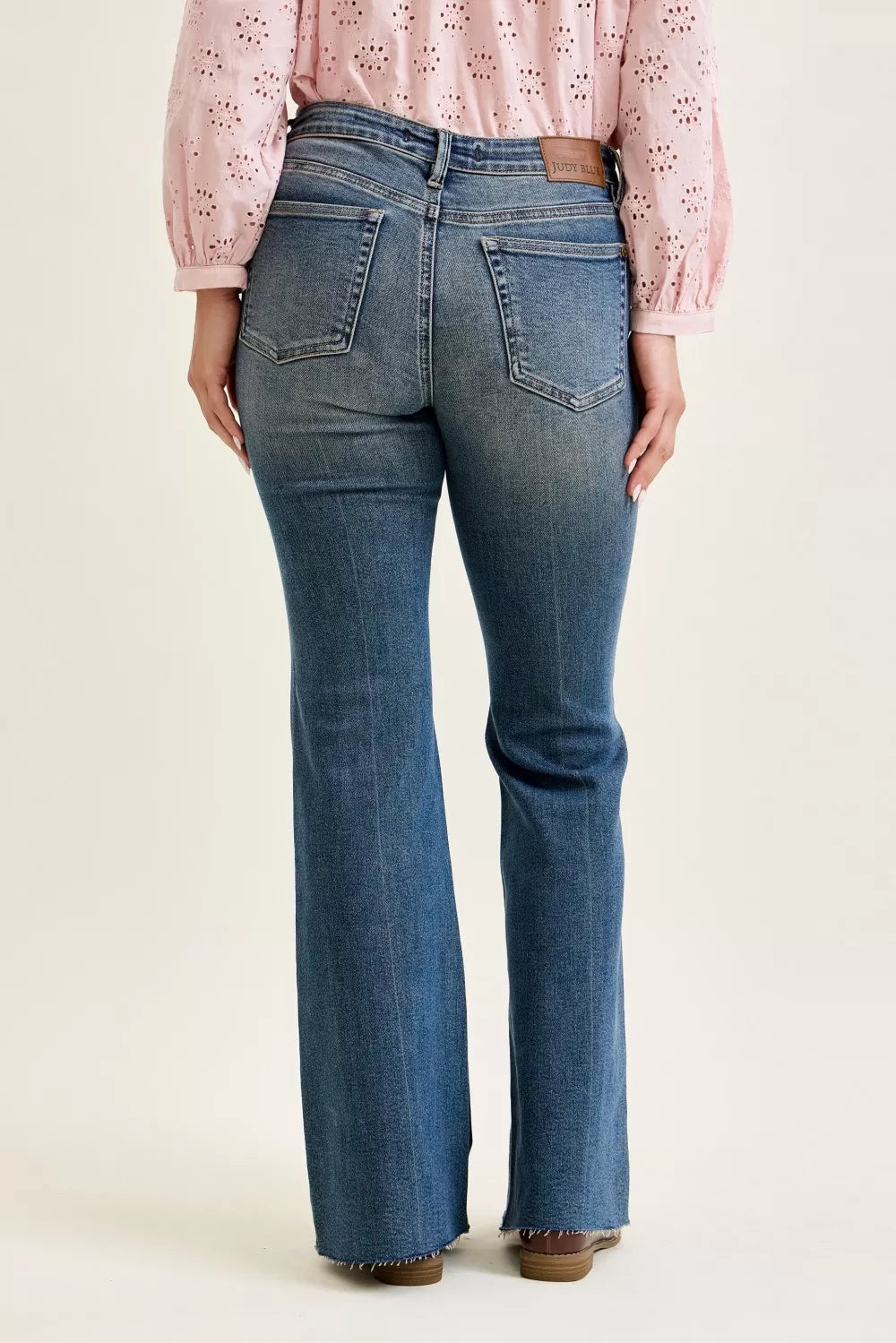 Judy Blue mid-rise flare jeans with front flap pockets and raw hem