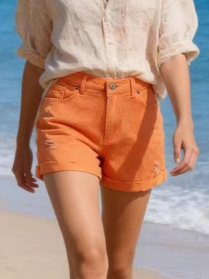 High-rise distressed denim shorts with cuffed hem