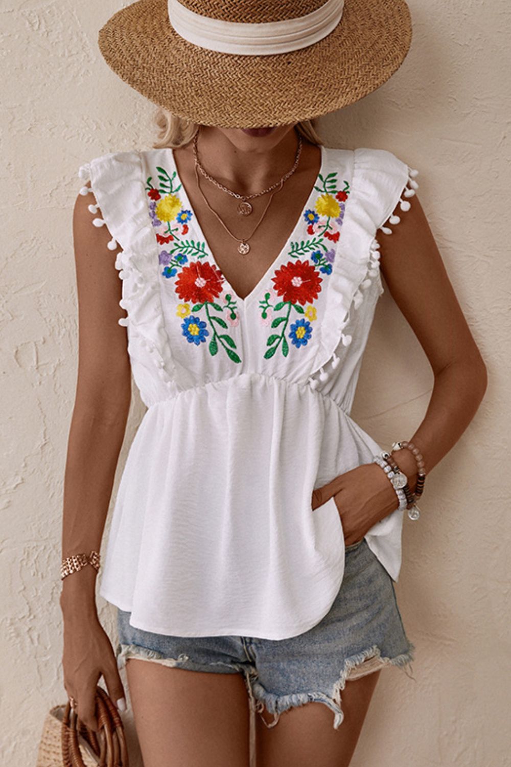 Embroidered floral babydoll top with pom-pom trim