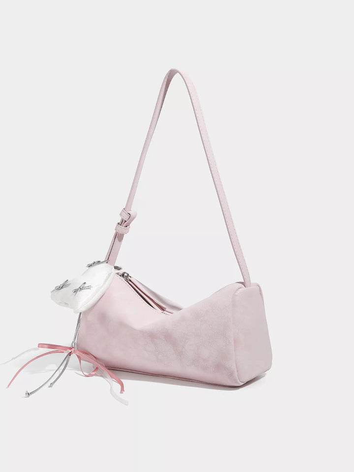 Adjustable strap crossbody bag with heart charm and bow trim