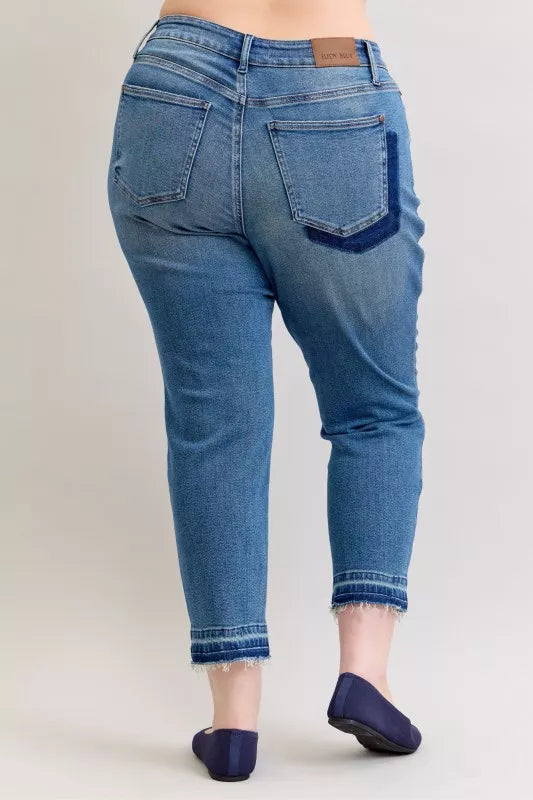 Distressed mid-rise boyfriend jeans with released raw hem