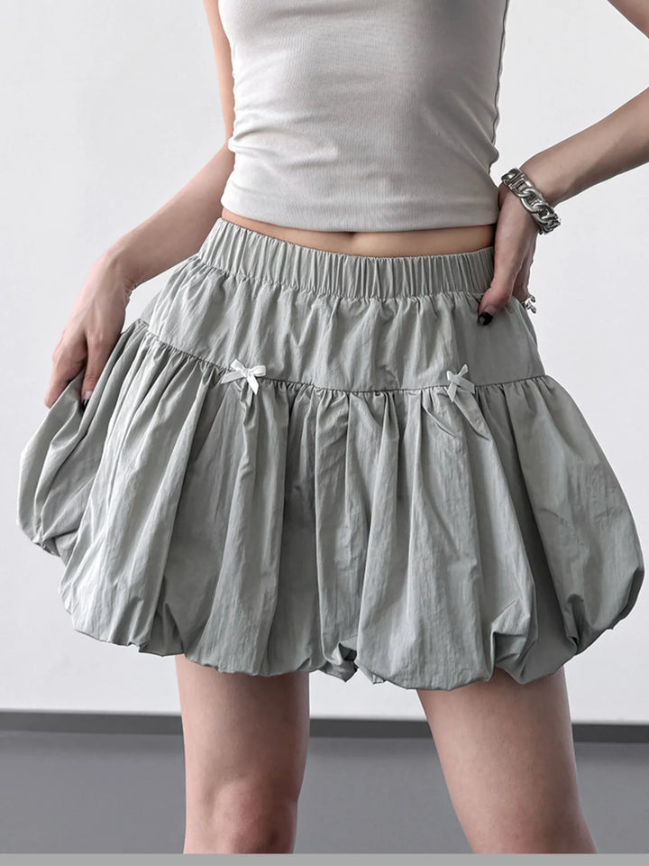 Bubble hem mini skirt with bow trim and elastic waist