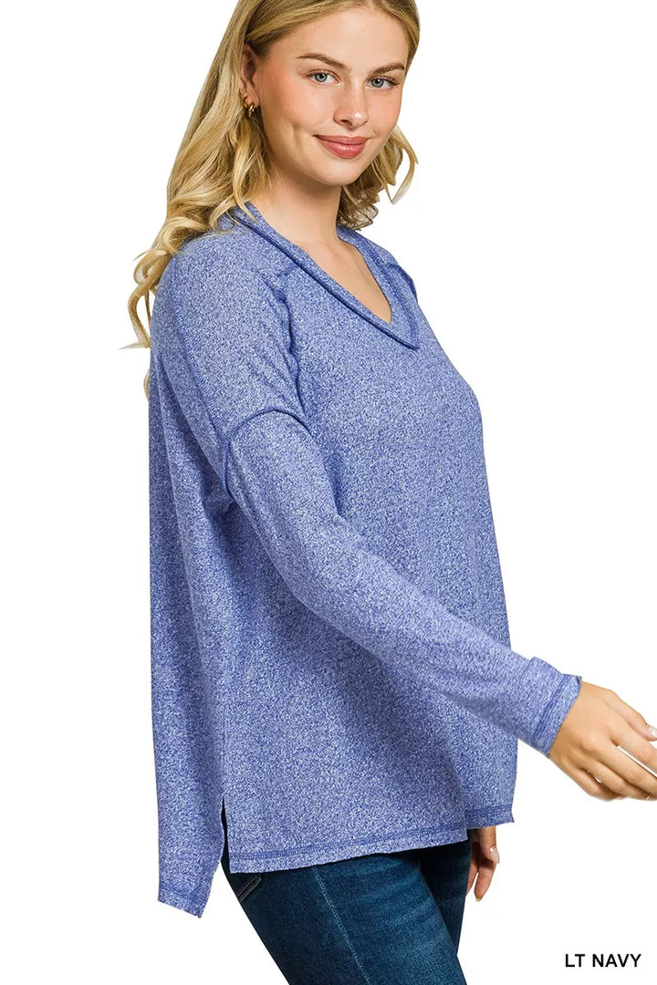 Exposed-seam melange knit hi-low long sleeve top