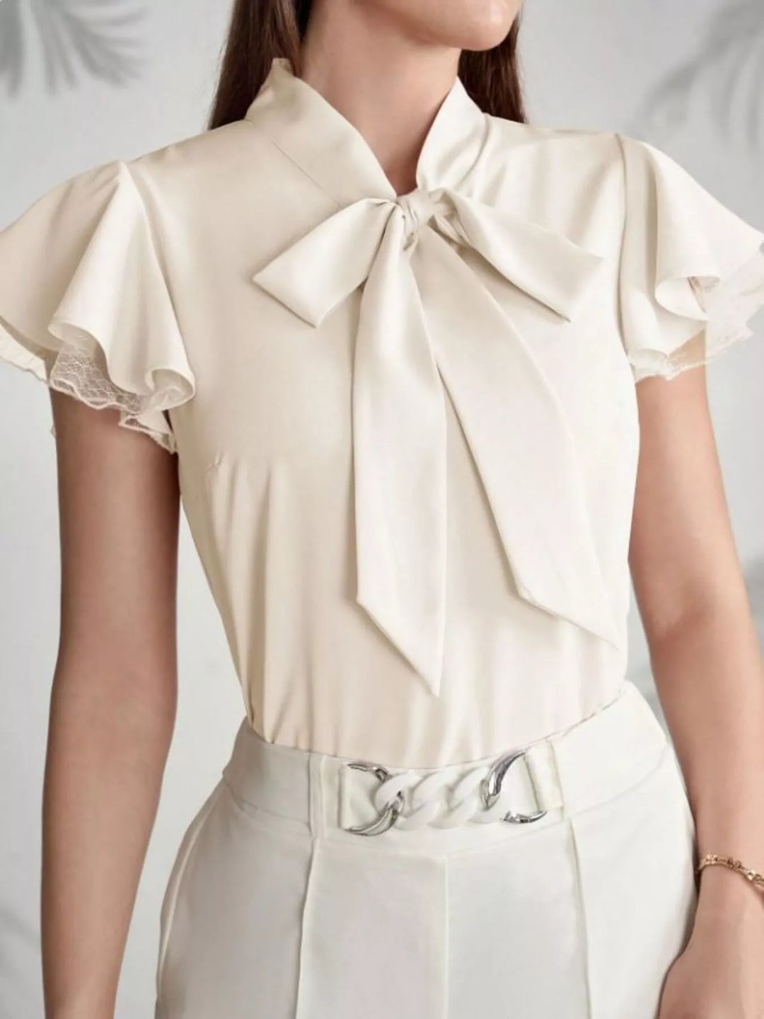 Tie-neck ruffle cap sleeve blouse with lace trim