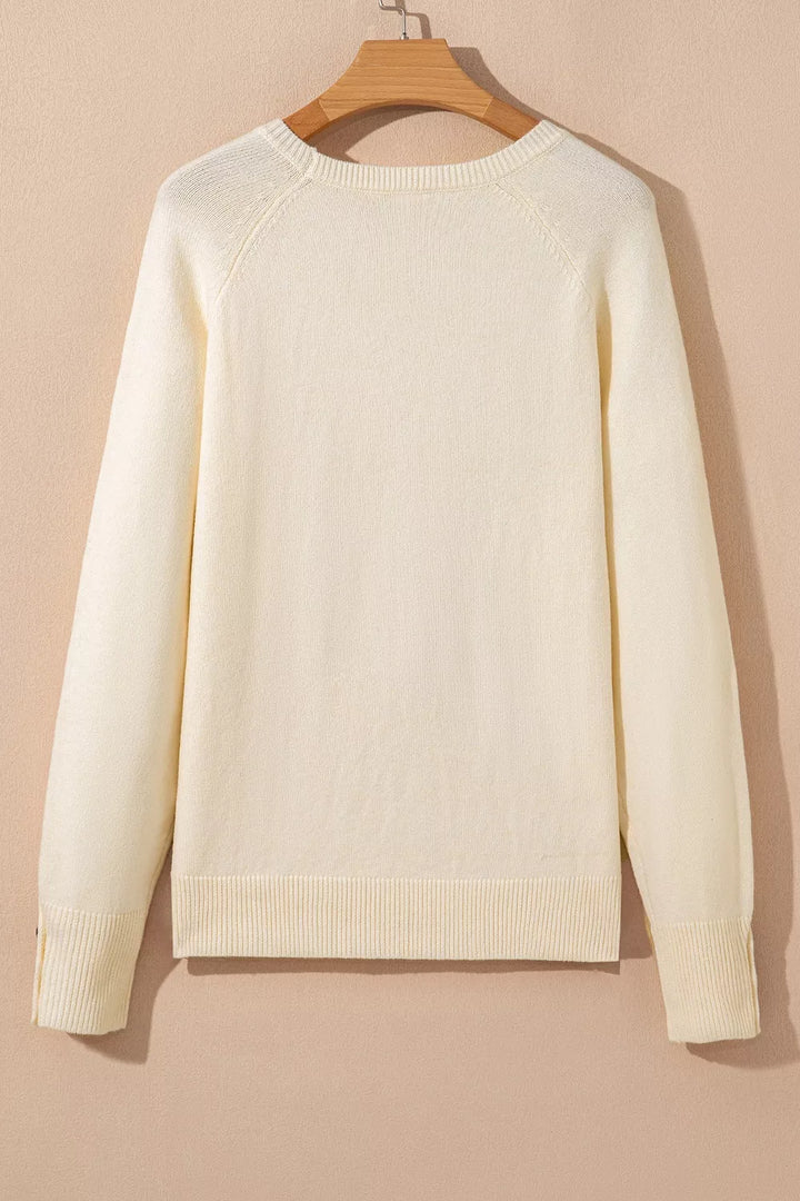 Button-cuff raglan sleeve crew neck sweater