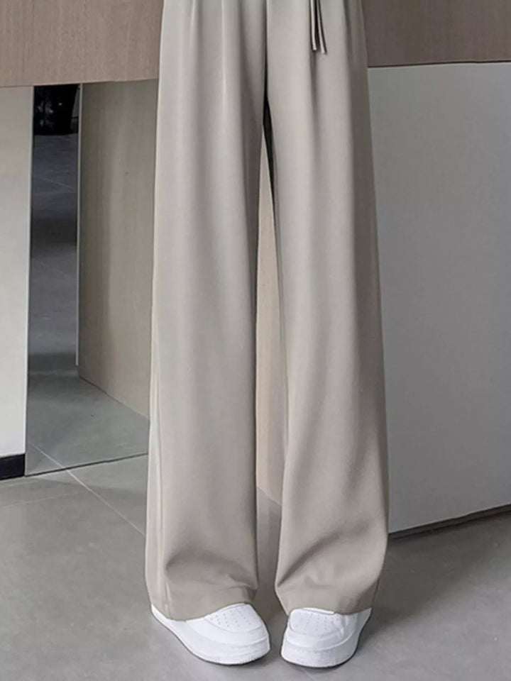 High-rise wide-leg pants with pleated front and tie waist