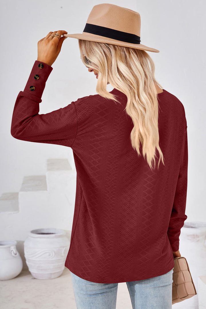 Textured knit V-neck long sleeve top with button cuffs