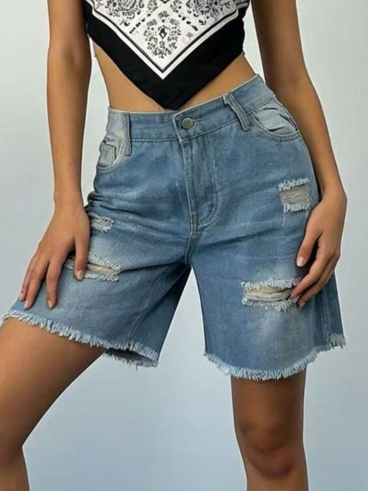 Distressed mid-thigh denim shorts with raw frayed hem