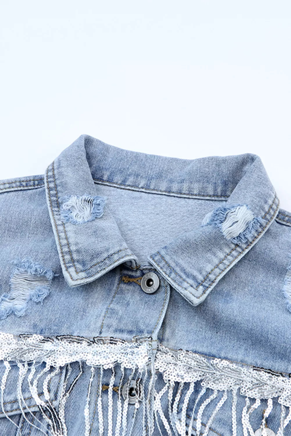 Distressed denim jacket with sequin fringe and chest pockets