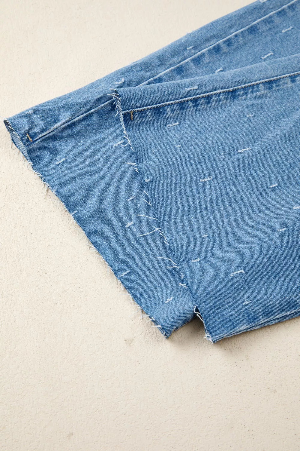 Distressed wide-leg jeans with tummy control and raw hem