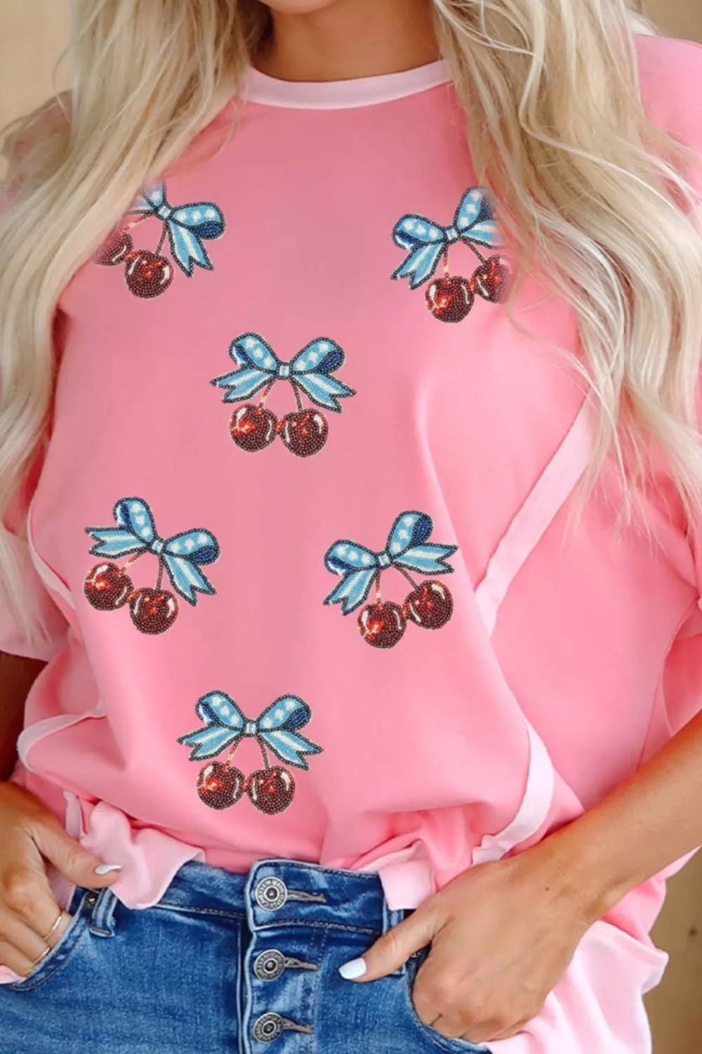 Sequin cherry and bow graphic raw seam crew neck top