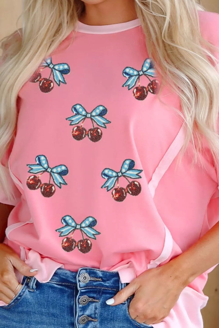 Sequin cherry and bow graphic raw seam crew neck top