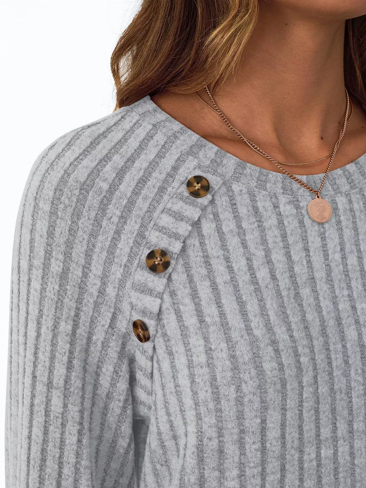 Ribbed knit long sleeve top with decorative shoulder buttons