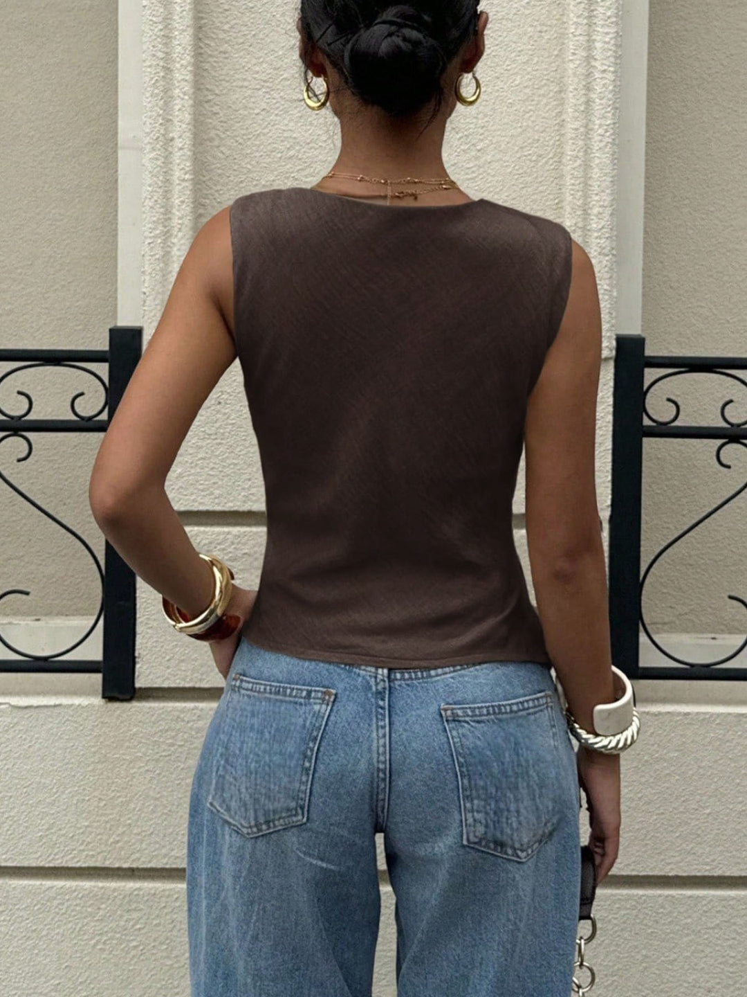 Draped cowl neck sleeveless top with asymmetrical hem