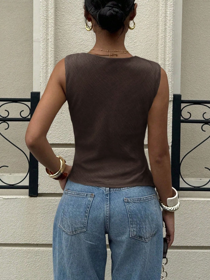 Draped cowl neck sleeveless top with asymmetrical hem