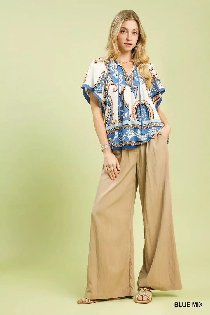 Relaxed paisley border print top with tassel tie neckline