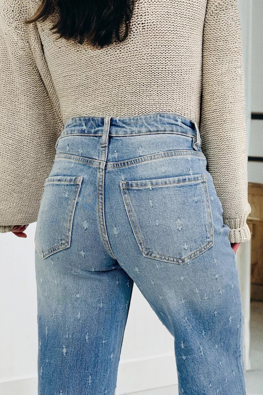 Distressed wide-leg jeans with tummy control and raw hem