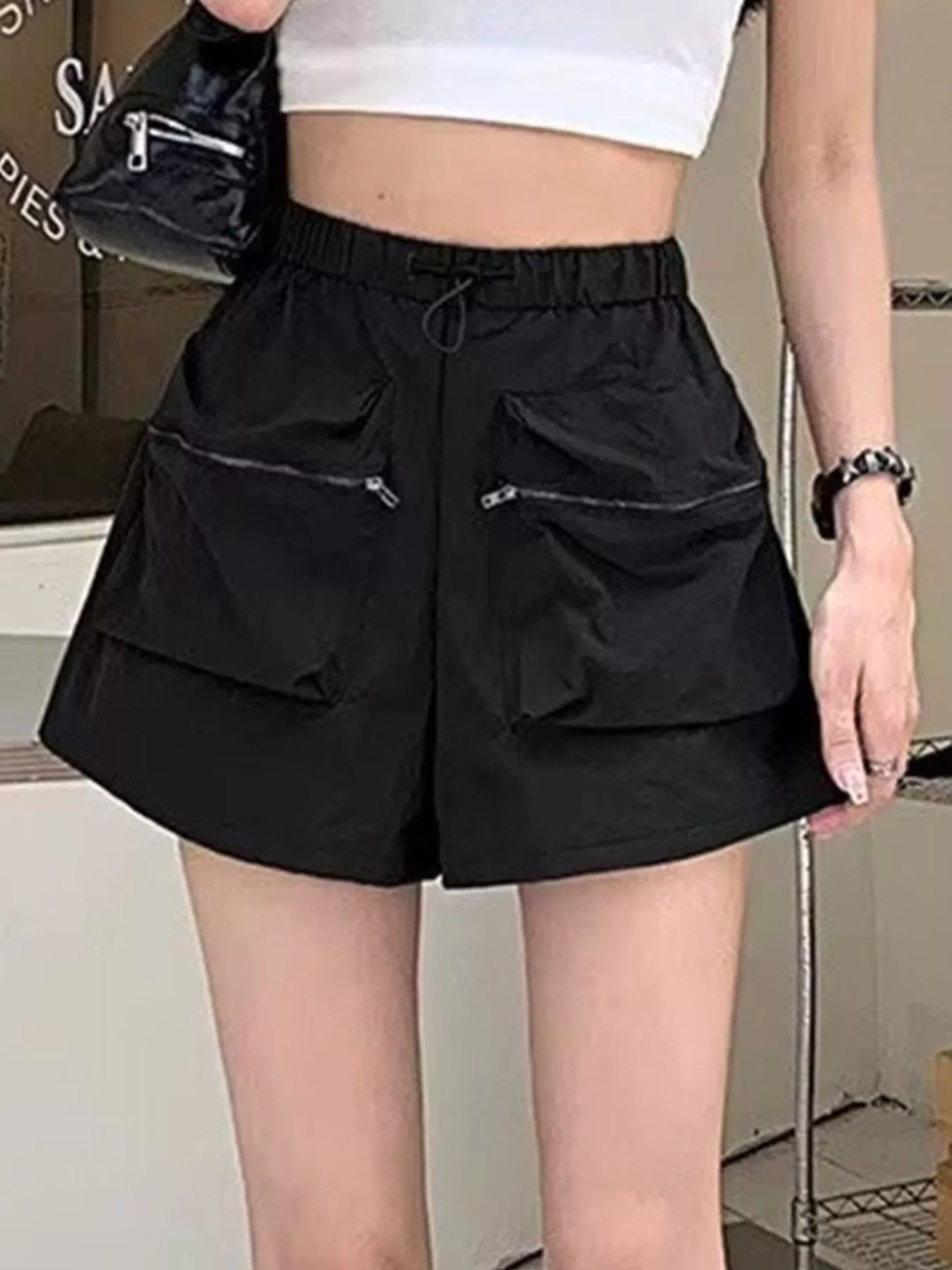 High-rise cargo shorts with zip pockets and drawstring waist