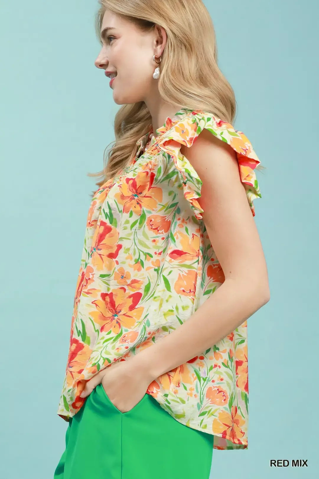 Smocked yoke flutter sleeve floral blouse with split V-neck