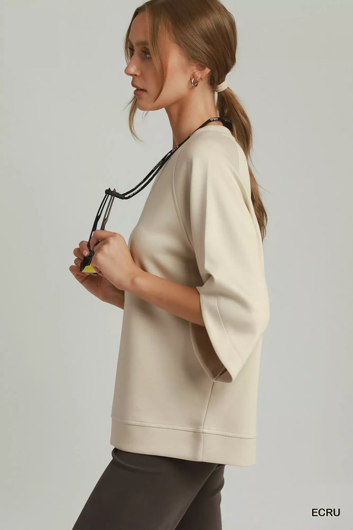 Relaxed raglan pullover with wide sleeves and ribbed hem