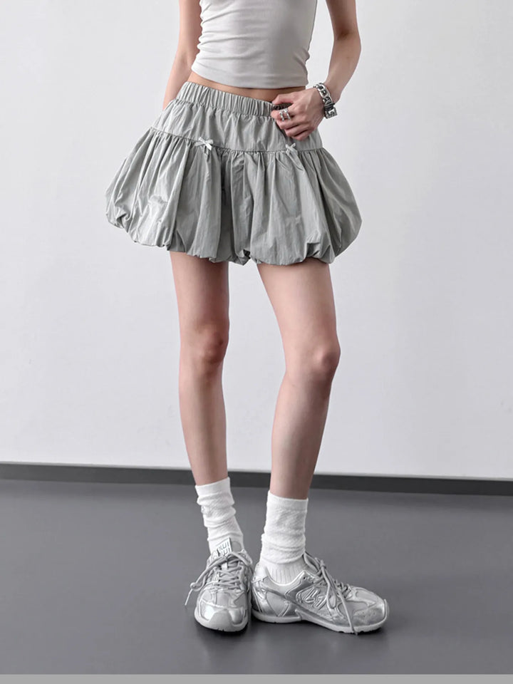 Bubble hem mini skirt with bow trim and elastic waist