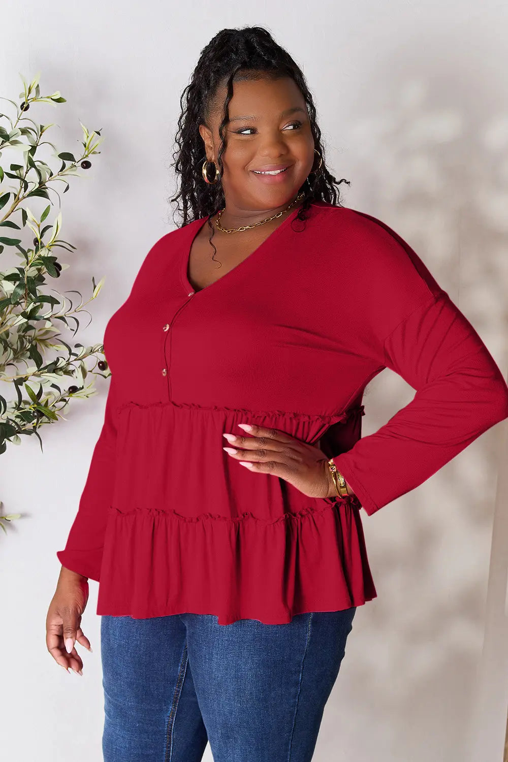 Half-button long sleeve blouse with tiered ruffle hem