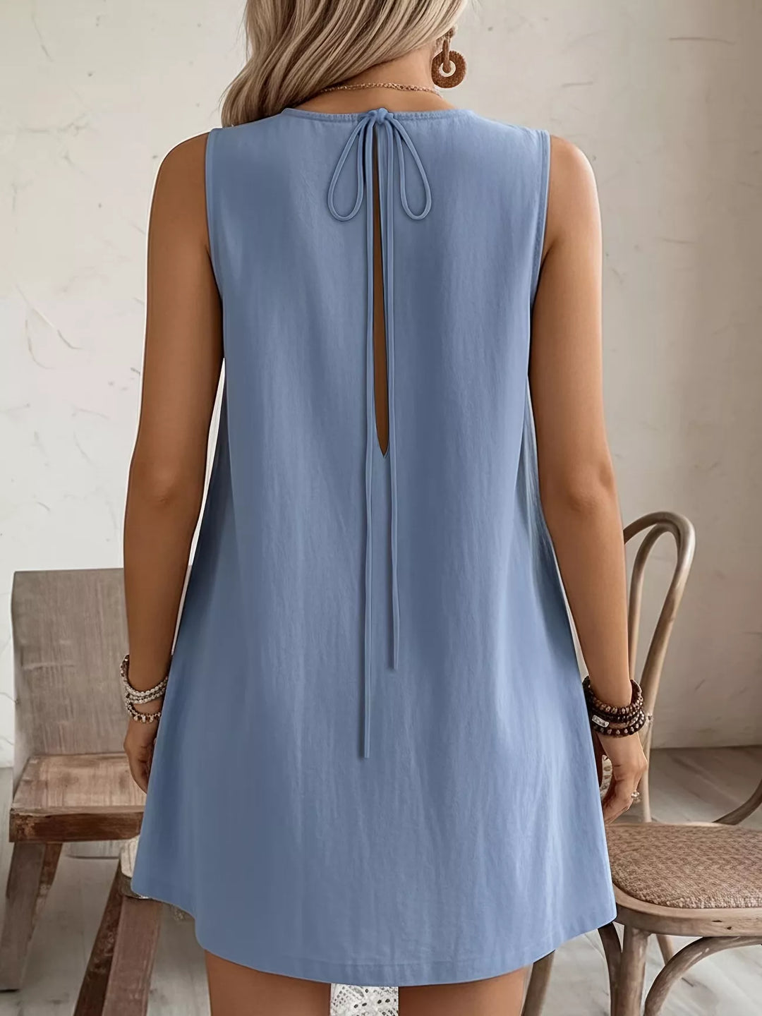 Ruffle-trim sleeveless mini dress with side pockets