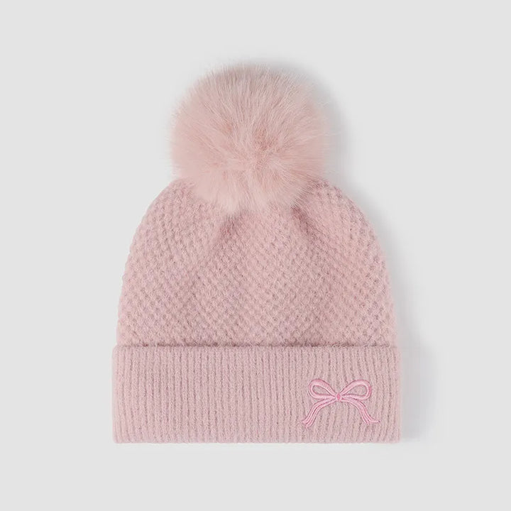 Pink Waffle knit beanie with embroidered bow and faux fur pompom