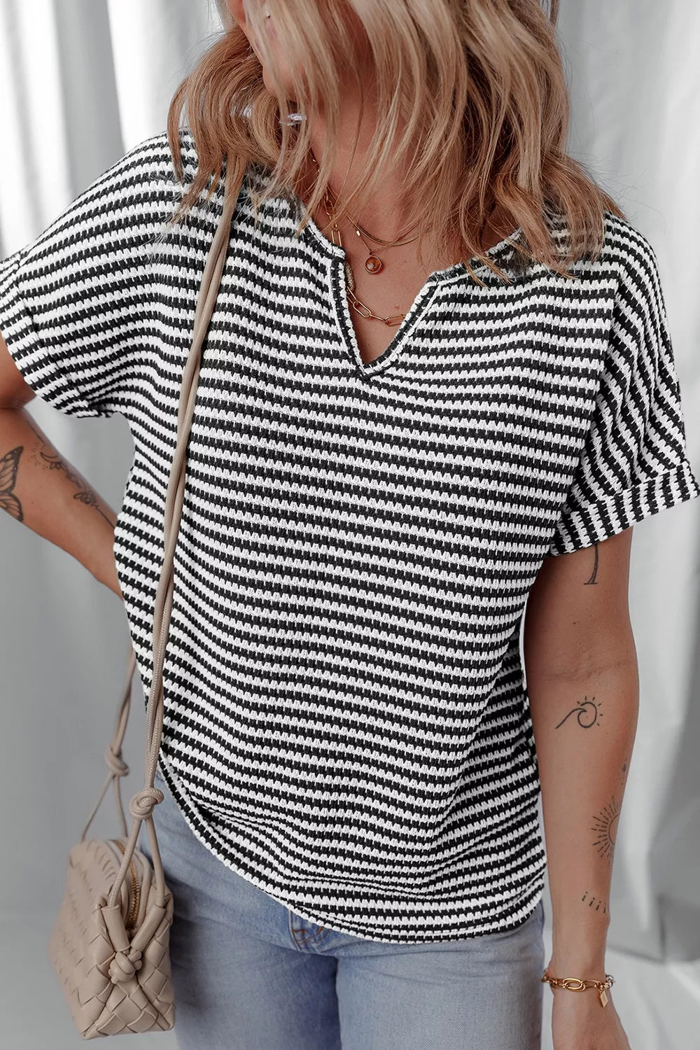 Striped textured knit top with notched V-neck and cuffed sleeves