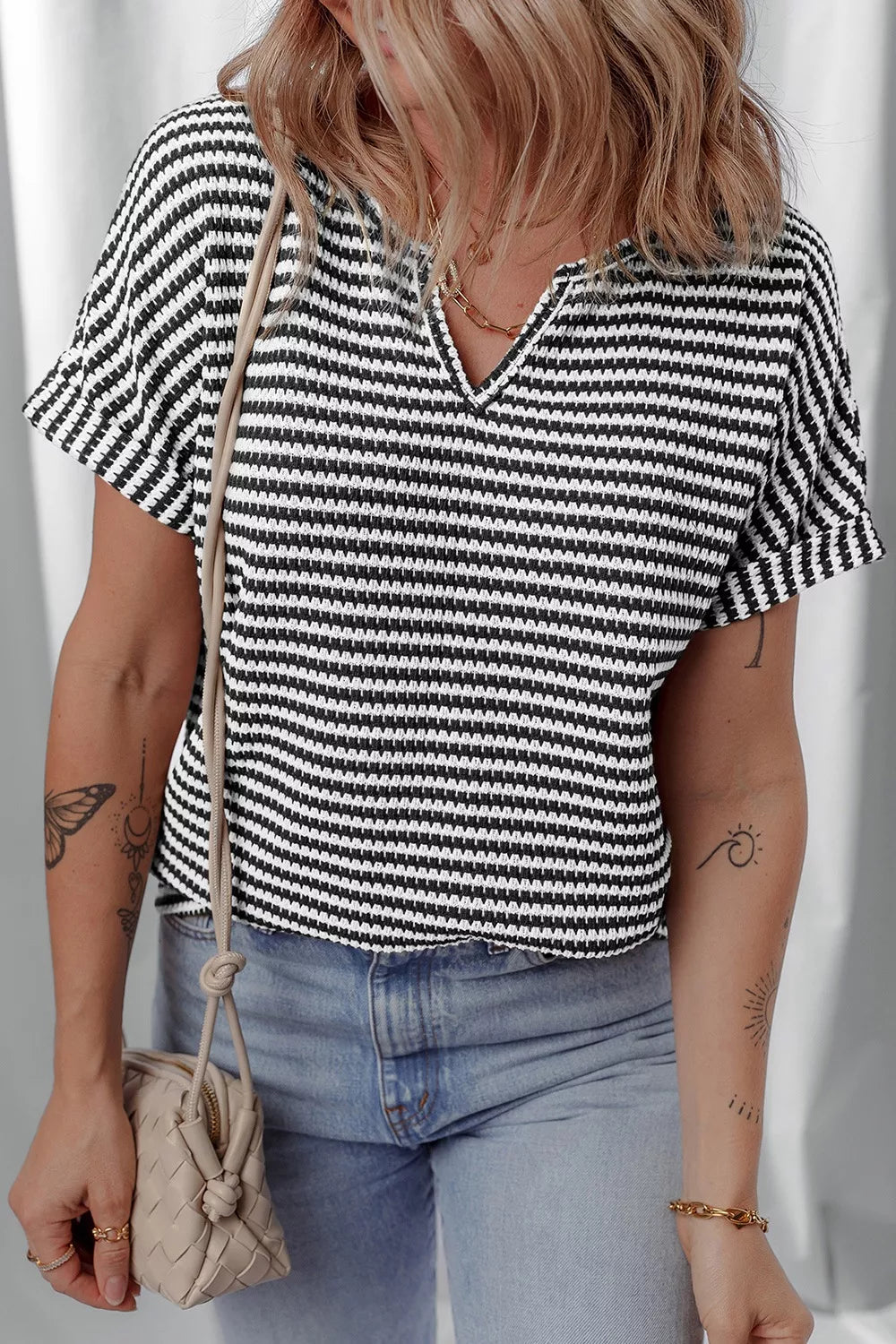 Striped textured knit top with notched V-neck and cuffed sleeves