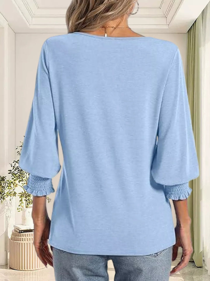 Notched V-neck three-quarter sleeve top with smocked cuffs