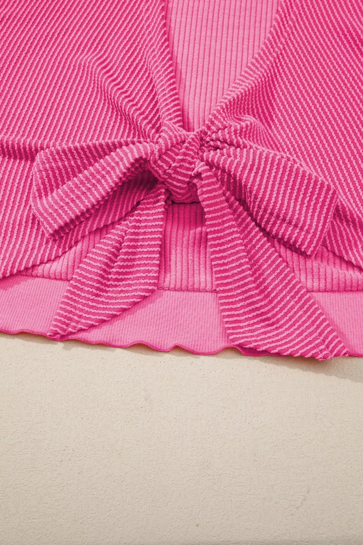 Ribbed knit short sleeve top with cutout bow-tie back