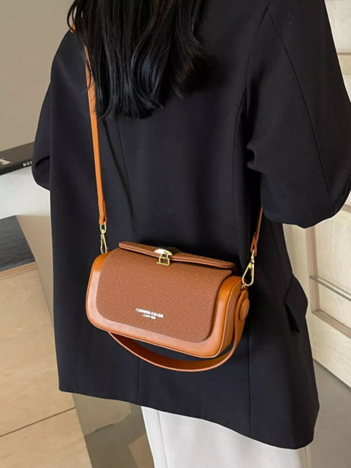 Structured boxy crossbody bag with gold clasp and top handle