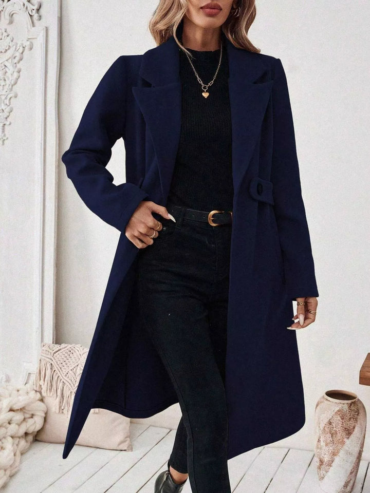 Longline notch lapel coat with single-button waist tab