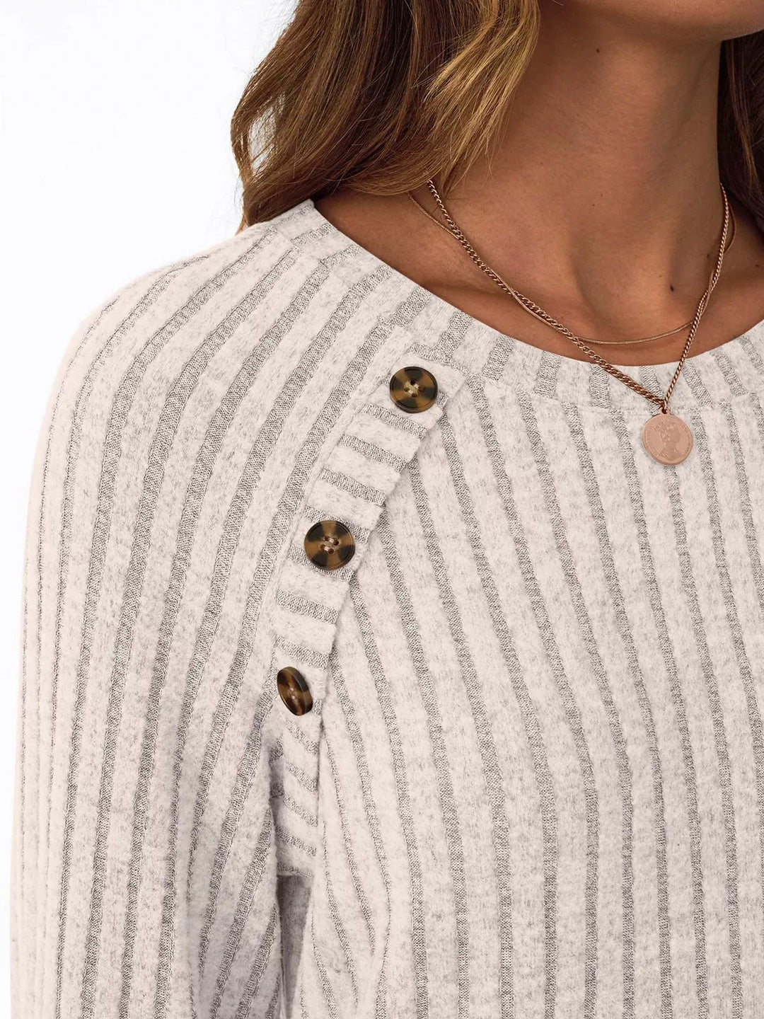 Ribbed knit long sleeve top with decorative shoulder buttons