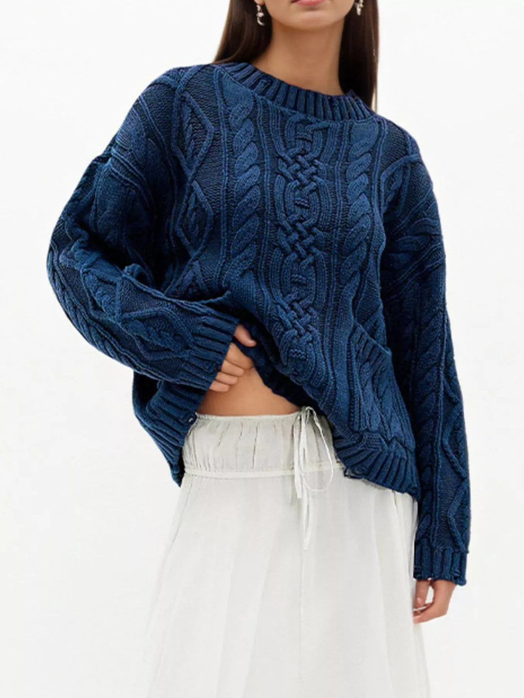 Cable knit sweater with patch pockets and raw hem