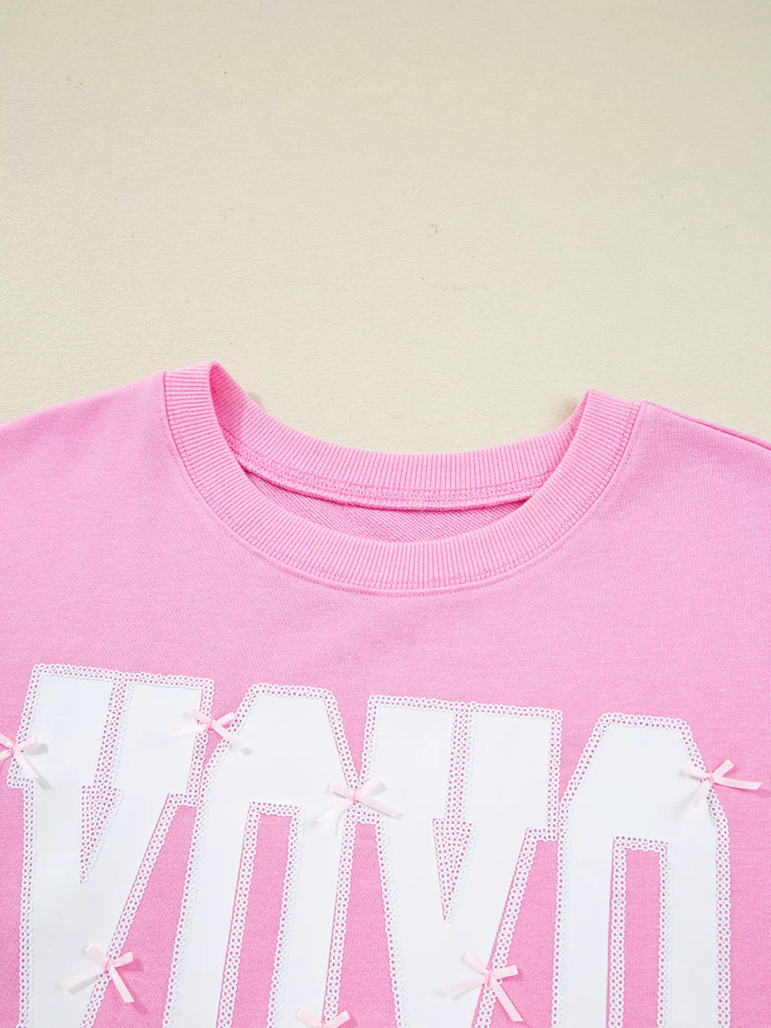 Oversized XOXO graphic sweatshirt with exposed seams and bows