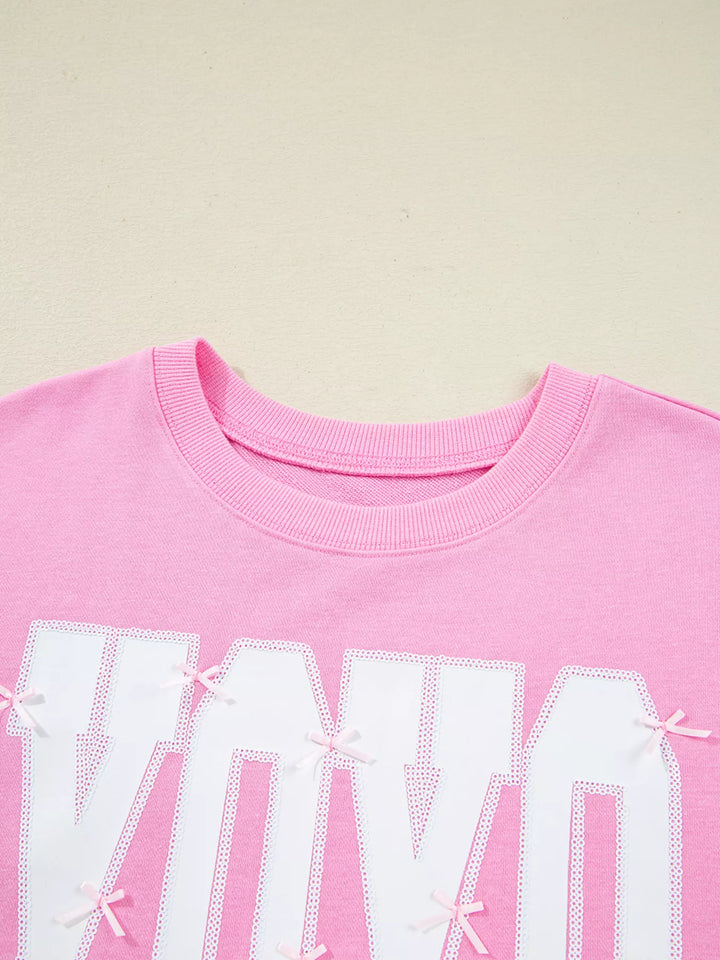 Oversized XOXO graphic sweatshirt with exposed seams and bows