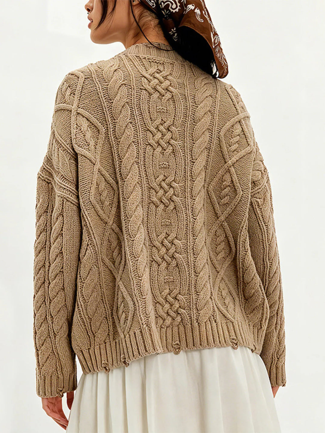 Cable knit sweater with patch pockets and raw hem