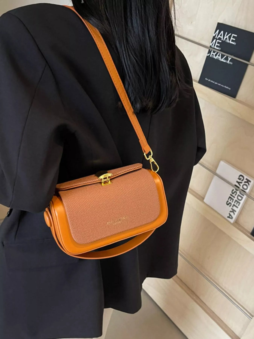 Structured boxy crossbody bag with gold clasp and top handle
