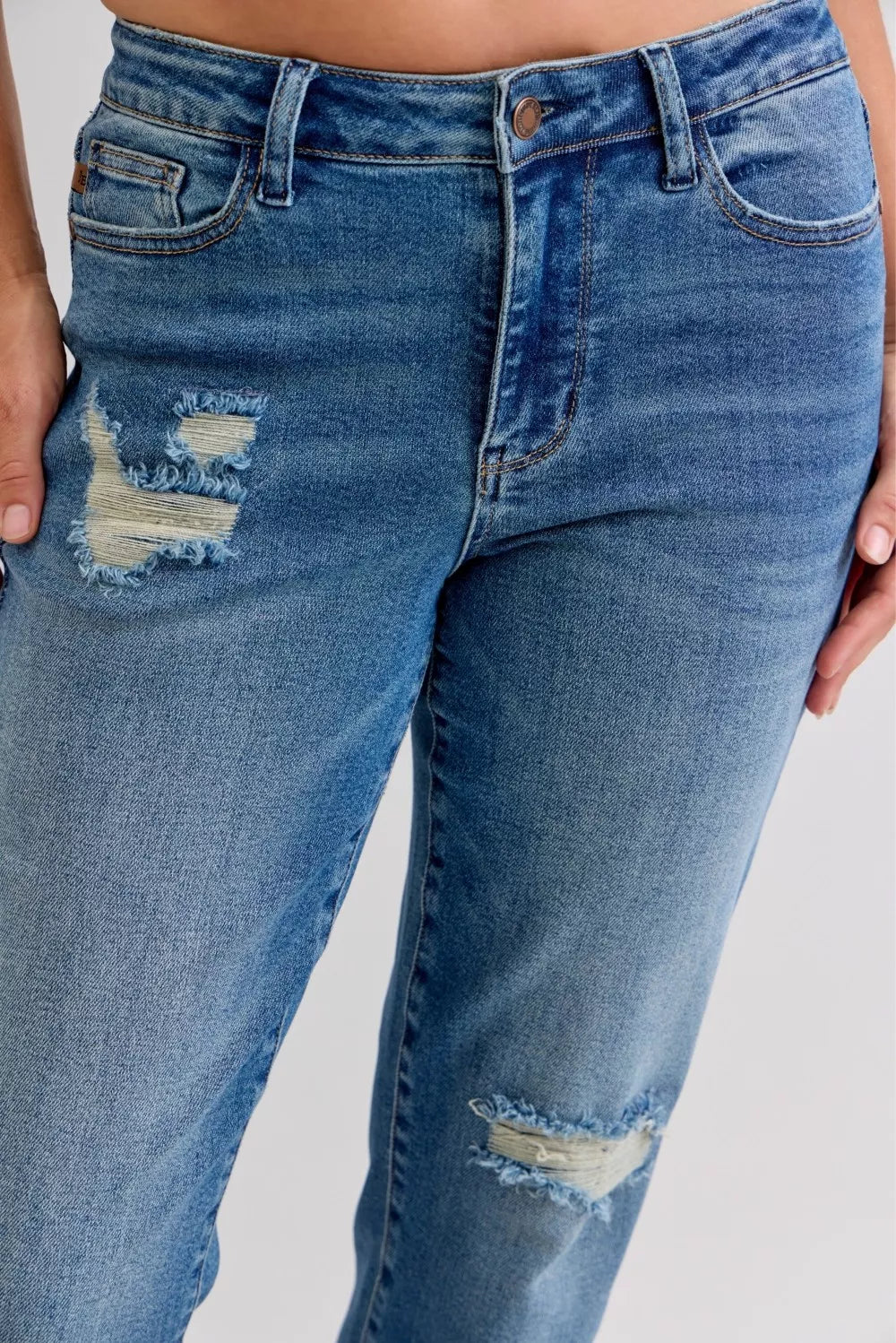 Distressed mid-rise boyfriend jeans with released raw hem
