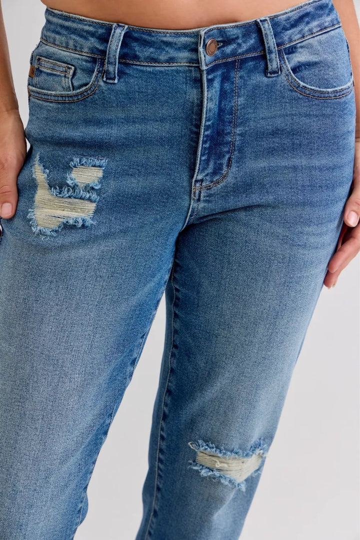 Distressed mid-rise boyfriend jeans with released raw hem