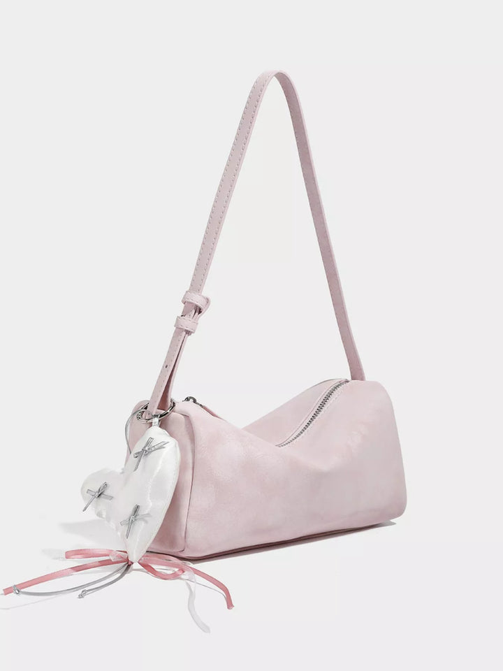 Adjustable strap crossbody bag with heart charm and bow trim