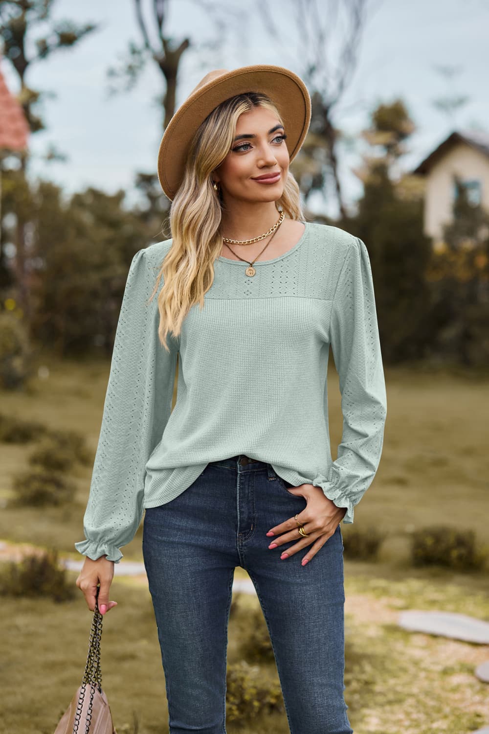 Eyelet knit puff sleeve blouse with round neckline